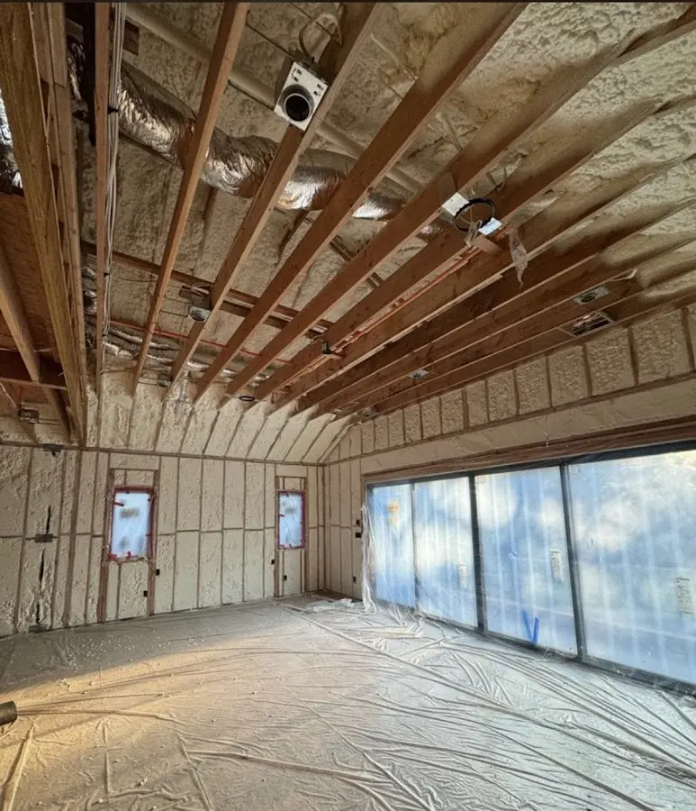 Interior walls and ceiling insulated with spray foam during new construction in St. James